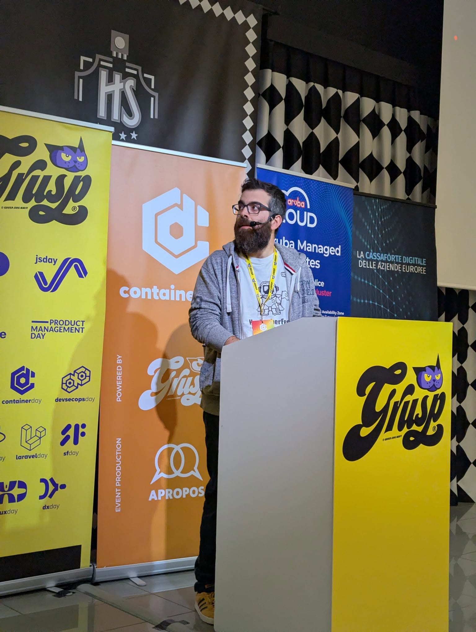 The ContainerDay 2026 stage in Bologna, with the GrUSP banners behind it